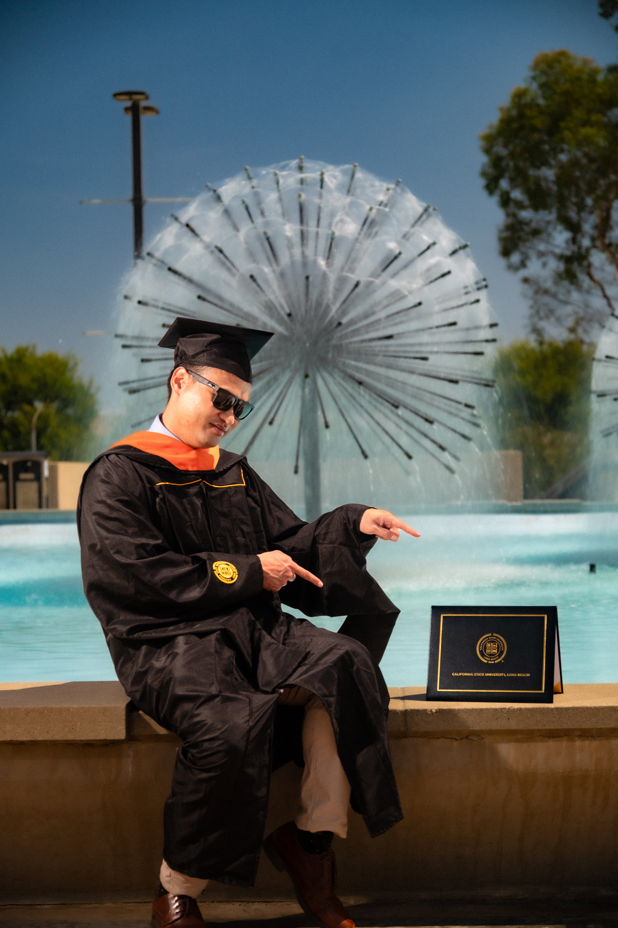 Graduate in a black cap and gown outdoors