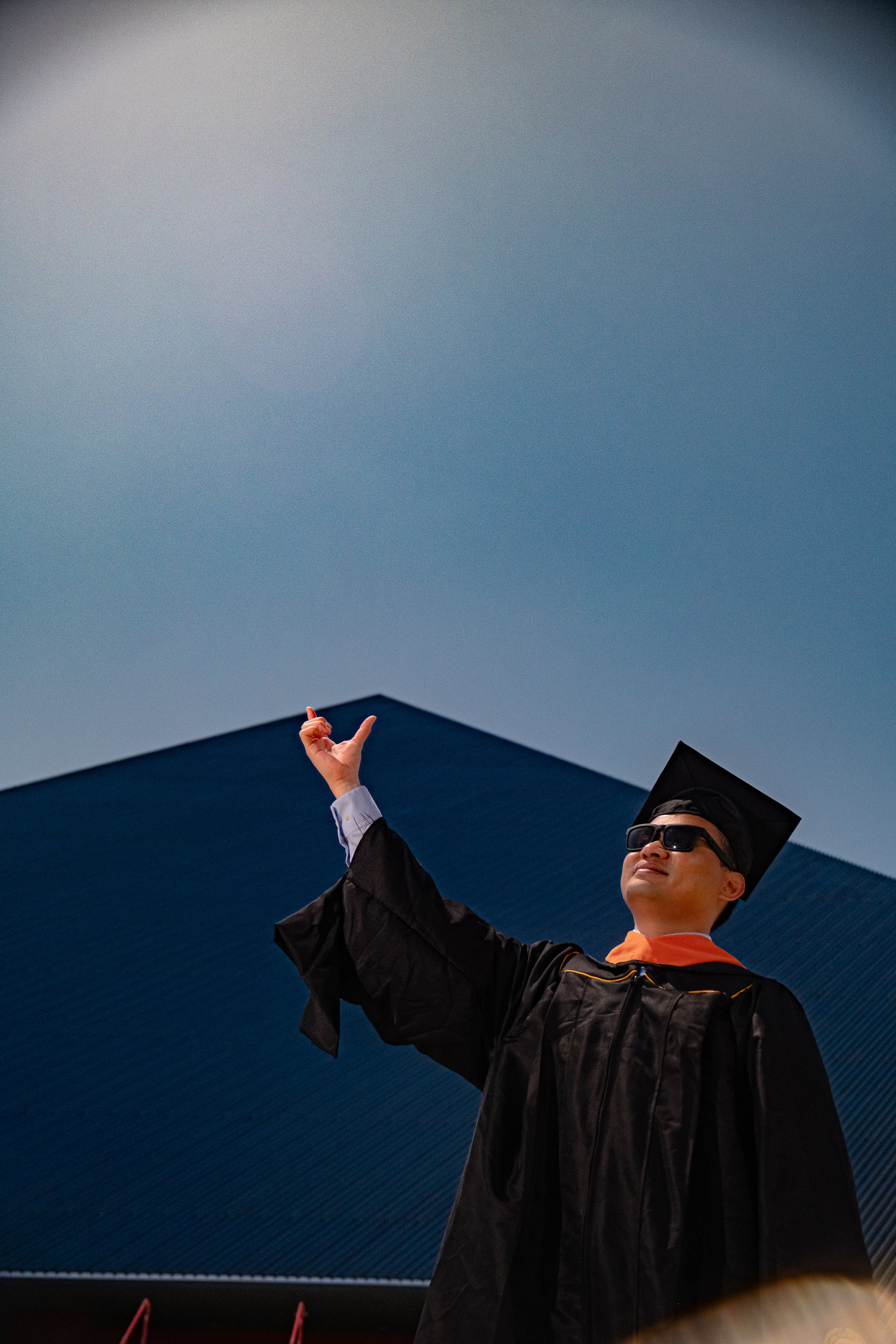 Graduate in a black cap and gown outdoors